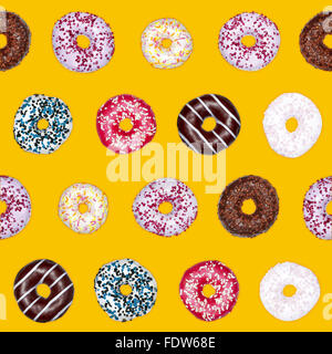 Seamless pattern of mixed chocolate donuts on yellow background Stock Photo