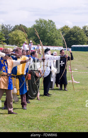 TEWKESBURY, GLOC. UK-11 JULY: Re-enactors in costume compete in longbow archery competition on 11 July 2014 at Tewkesbury Mediev Stock Photo