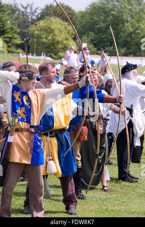 TEWKESBURY, GLOC. UK-12 JULY: Re-enactors compete in longbow archery competition on 12 July 2014 at Tewkesbury Medieval Festival Stock Photo