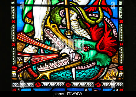 Stained glass window showing St George killing a dragon, UK.