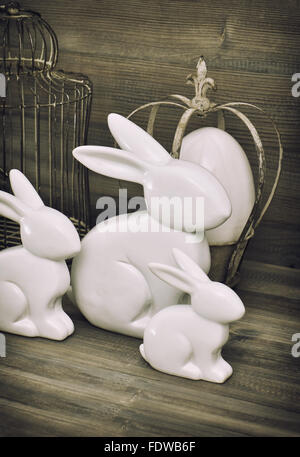 Easter bunny and easter eggs on rustic wooden background. Vintage decoration Stock Photo