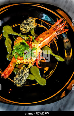 Tiger Prawn with Couscous, Coriander Sauce and Squid Croquette Stock Photo