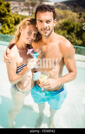 Happy couple holding cocktails Stock Photo