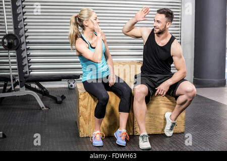 Fit couple doing high five Stock Photo