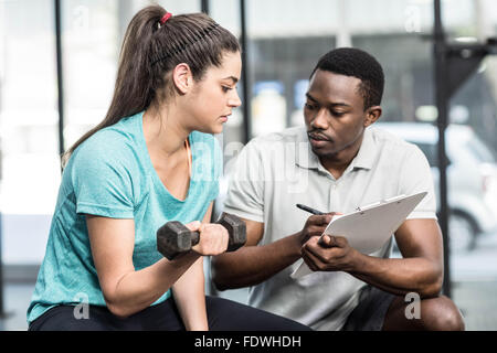 Trainer giving advice to woman Stock Photo