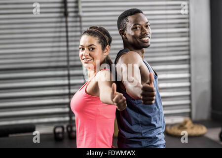 Fit couple back to back Stock Photo