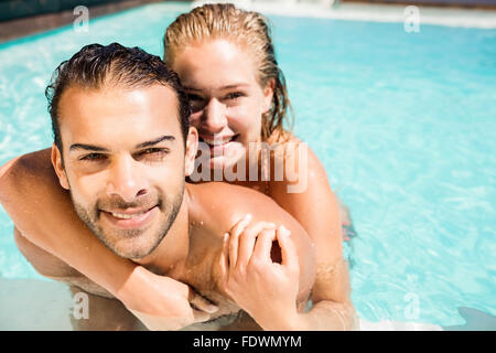 Happy couple embracing in the pool Stock Photo