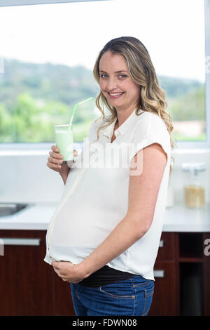 Pregnant woman drinking a smoothie Stock Photo