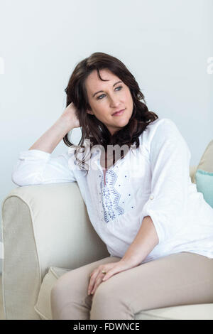 Pregnant woman sitting in the living room Stock Photo