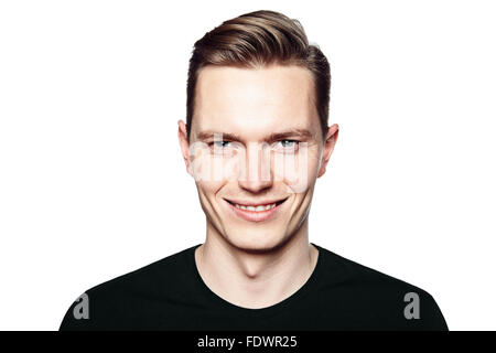 Studio shot of young handsome man with ironic smile. Isolated on white background. Stock Photo