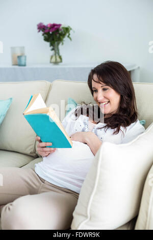 Pregnant woman reading a book Stock Photo