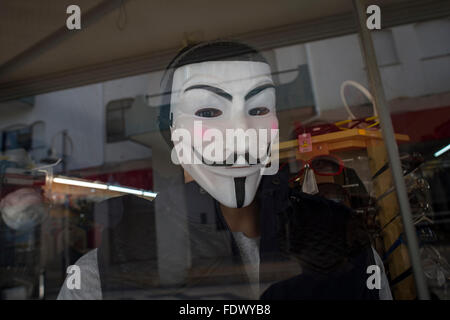 A demonstrator wearing a Guy Fawkes mask stands near the Arc de ...