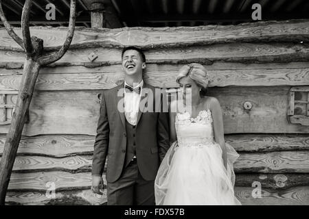 beautiful young wedding couple stands near house Stock Photo