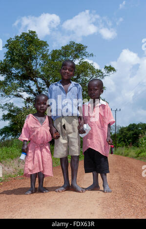 Boy walking barefoot on rural road Stock Photo - Alamy