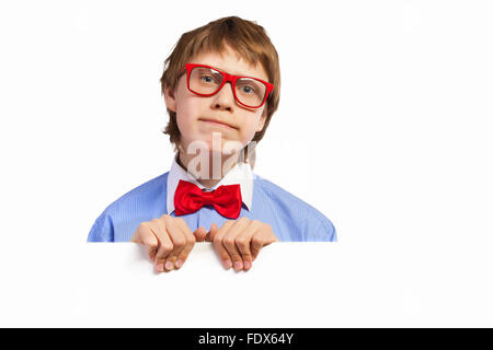 Image of confused boy holding white square. Place for advertisement Stock Photo