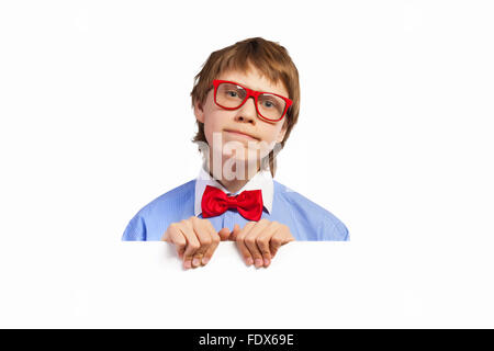 Image of confused boy holding white square. Place for advertisement Stock Photo