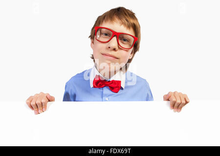 Image of confused boy holding white square. Place for advertisement Stock Photo