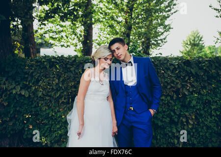 Beautiful wedding couple posing in the park Stock Photo