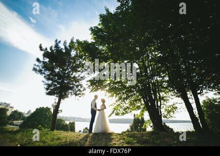 bride groom standing in the park Stock Photo