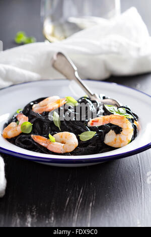 Squid ink homemade pasta with shrimp basil Stock Photo