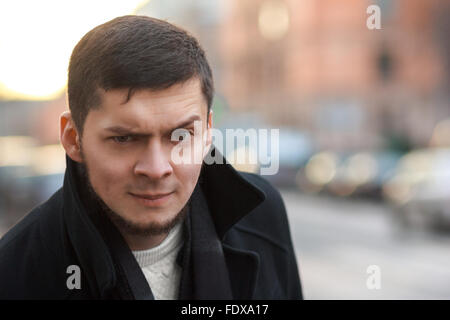 Portrait of a man with a raised eyebrow outdoor Stock Photo