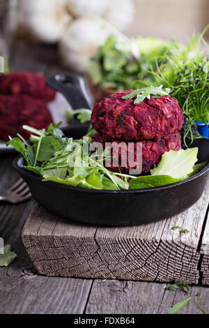 Beet root and red bean vegan burgers with salad Stock Photo