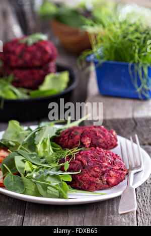Beet root and red bean vegan burgers with salad Stock Photo
