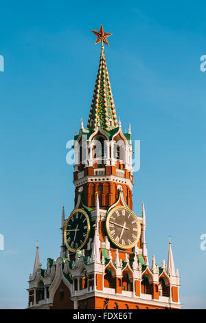 The Kremlin chimes, big main clock and ruby star of Spasskaya Saviour Tower of Moscow Kremlin on blue sky of Red Square, Russia Stock Photo