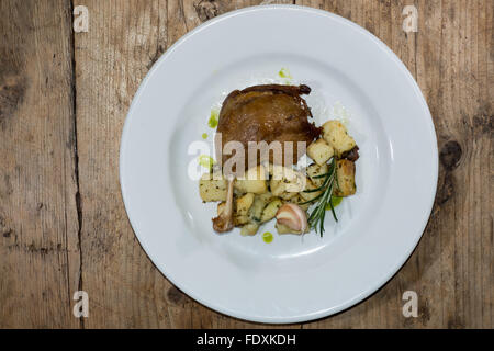 Classic French dish with herbs, garlic and potatoes cooked in goose fat Stock Photo