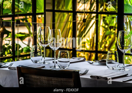 Hanging lights and elegant table setting inFrench restaurant or dining room Stock Photo
