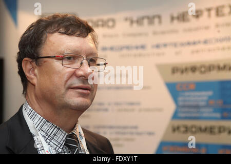 One of Russia's leading petrochemical engineers Dr Alexander Shakun pictured near boot of his company NPP Neftehim at the EPC industrial conference Stock Photo