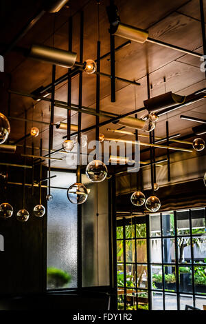 Hanging lights and elegant table setting inFrench restaurant or dining room Stock Photo