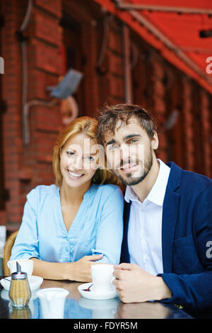 Amorous young couple having coffee in cafe Stock Photo