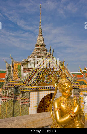 Golden statue at the Temple of the Emerald Buddha. Grand Palace. Bangkok, Thailand