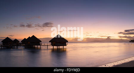 Overwater bungalows at Le Meridien Tahiti Hotel at sunset, Pape'ete, Tahiti, French Polynesia Stock Photo