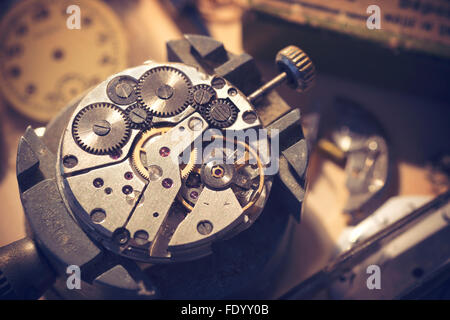 Old Watchmaker Studio. A watch makers work top. The inside workings of a vintage mechanical watch. Stock Photo