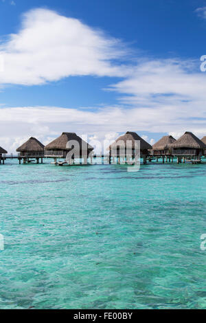 Overwater bungalows of Hilton Mo'orea Lagoon Resort Hotel, Moorea, Society Islands, French Polynesia Stock Photo