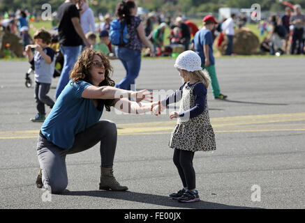 Berlin, Germany, mother kneels down in front of her daughter laughing Stock Photo