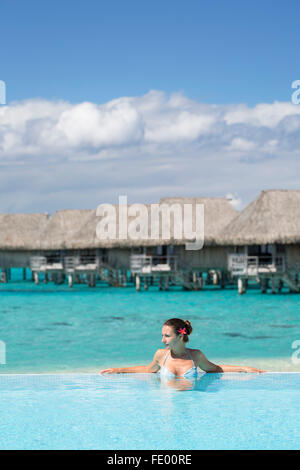 Woman in pool at Sofitel Hotel, Moorea, Society Islands, French Polynesia Stock Photo