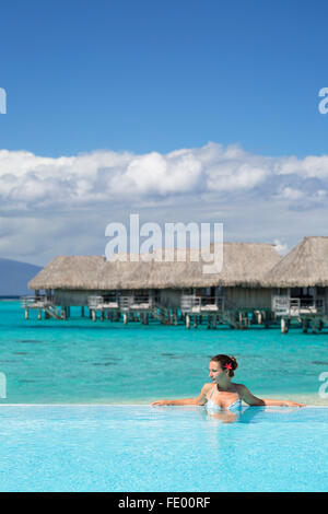 Woman in pool at Sofitel Hotel, Moorea, Society Islands, French Polynesia Stock Photo