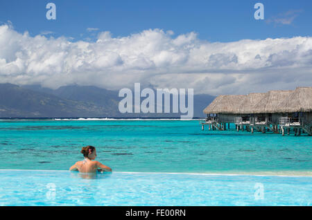 Woman in pool at Sofitel Hotel, Moorea, Society Islands, French Polynesia Stock Photo