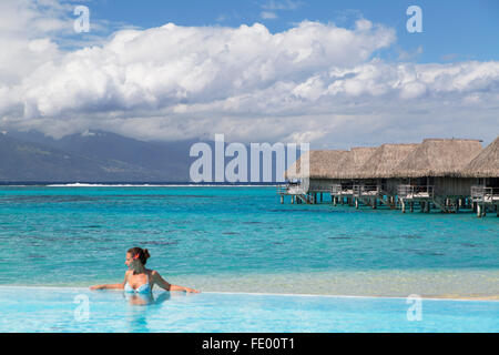 Woman in pool at Sofitel Hotel, Moorea, Society Islands, French Polynesia Stock Photo