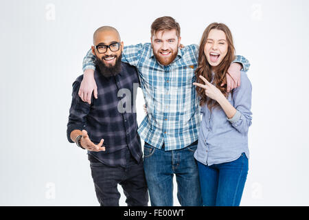 Group of happy three friends in casual wear standing and laughing Stock Photo