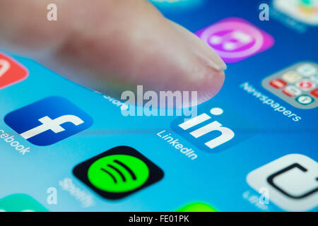 detail of user using LinkedIn professional social networking app on  smart phone Stock Photo