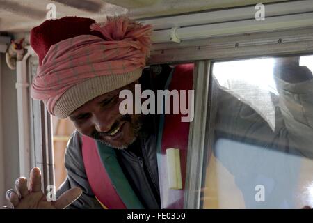A fisherman looks through a window. Stock Photo