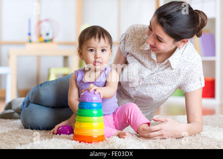 mom and kid playing block toys at home Stock Photo