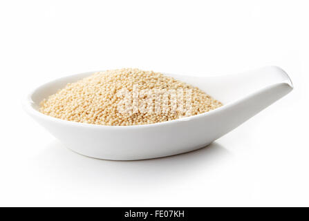 Amaranth seeds in white porcelain spoon on white background, isolated Stock Photo