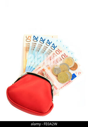 Red money purse containing fifty, twenty, ten Euro notes with some coins from Eurozone isolated on a plain white background from above. Europe Stock Photo