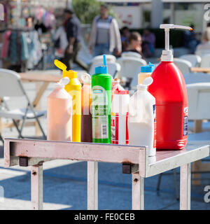 Plastic bottles of salt, tomato ketchup, mustard, mayonnaise and other sauces and toppings. Food stall at an outside event, Nottingham, England, UK Stock Photo
