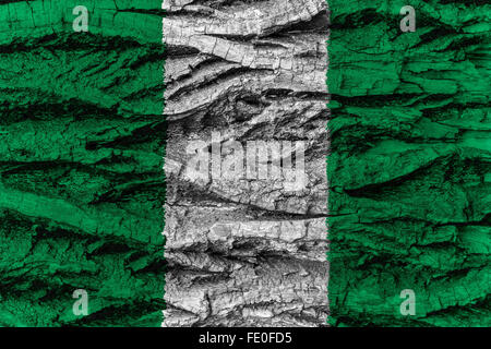 Nigeria national flag painted on wooden bark of tree. Painting is rough and colorful. Stock Photo